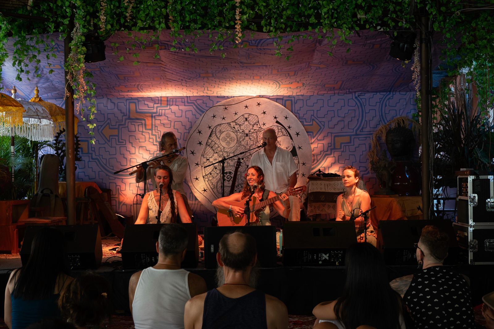 Francie playing kirtan on stage to a full room in Bali