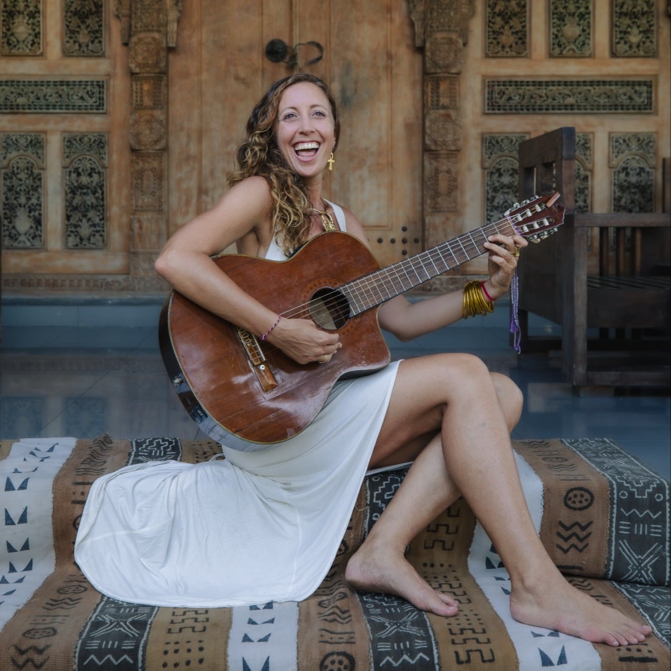 Francie La Flow laughing with her guitar in Ubud, Bali