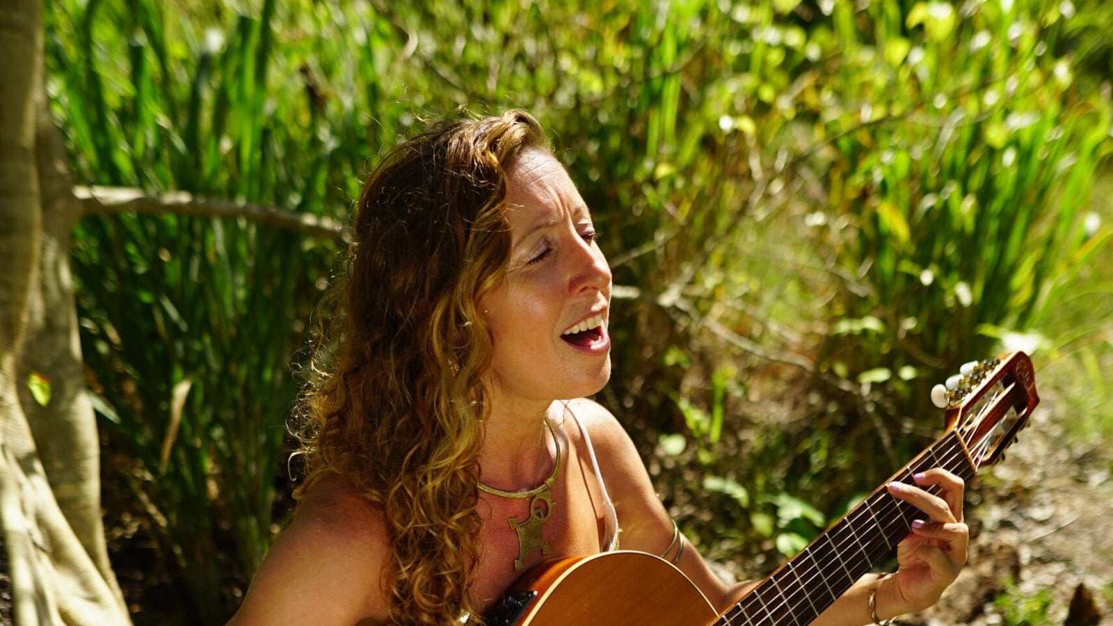 Francie singing with her guitar outdoors