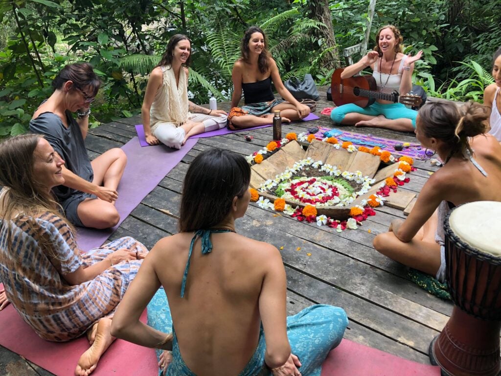 A singing circle gathered around a flower mandala