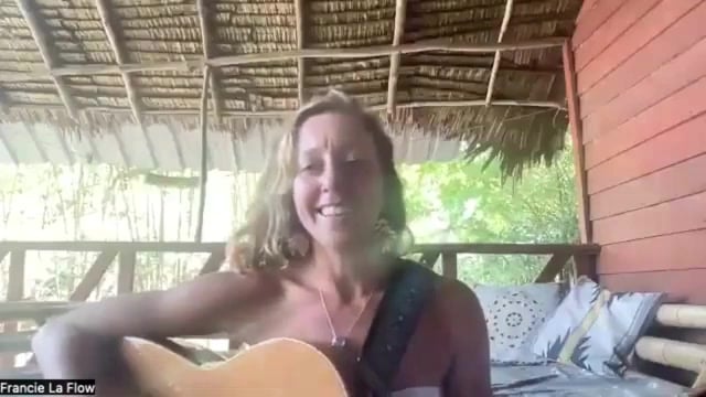 Francie La Flow singing and playing guitar during a live Vocal Flow practice session
