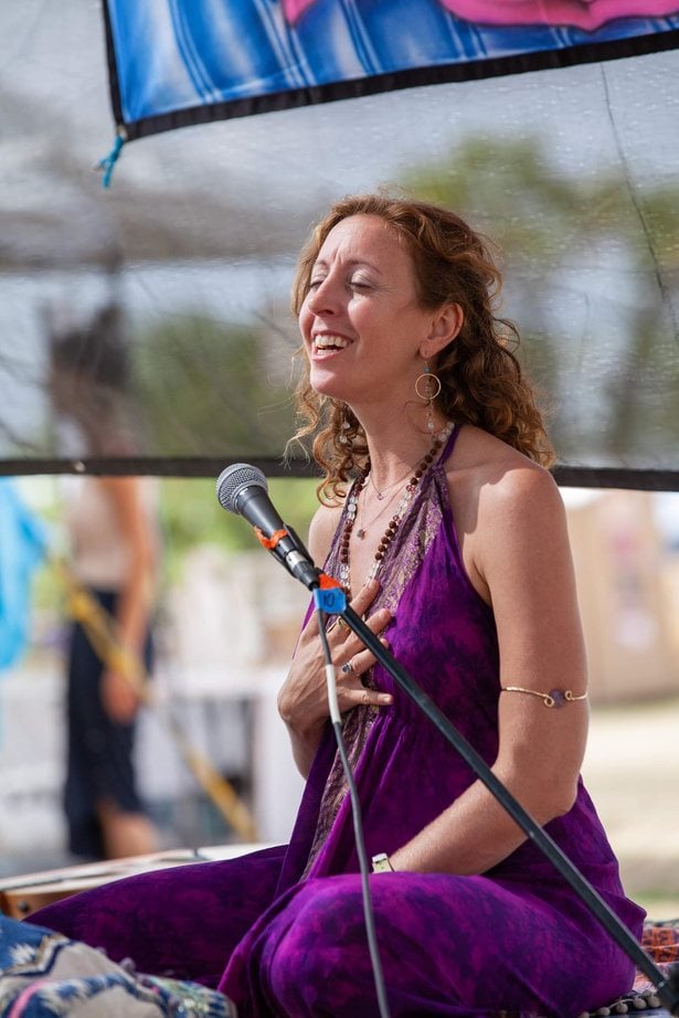 Francie singing into a microphone outdoors