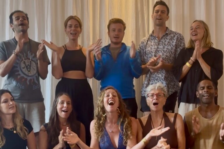A workshop group at The Yoga Barn singing and clapping together