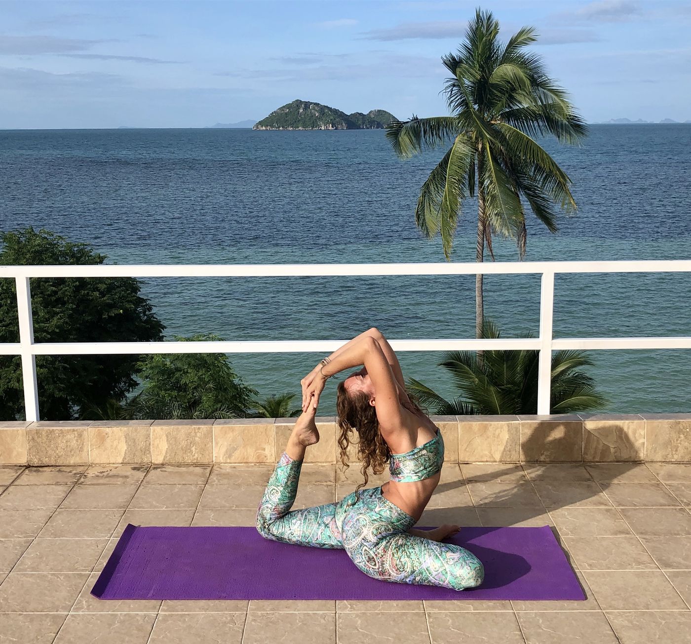 Francie in king pigeon pose, holding her back foot