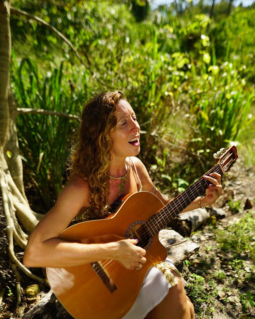 Francie singing and playing guitar outdoors
