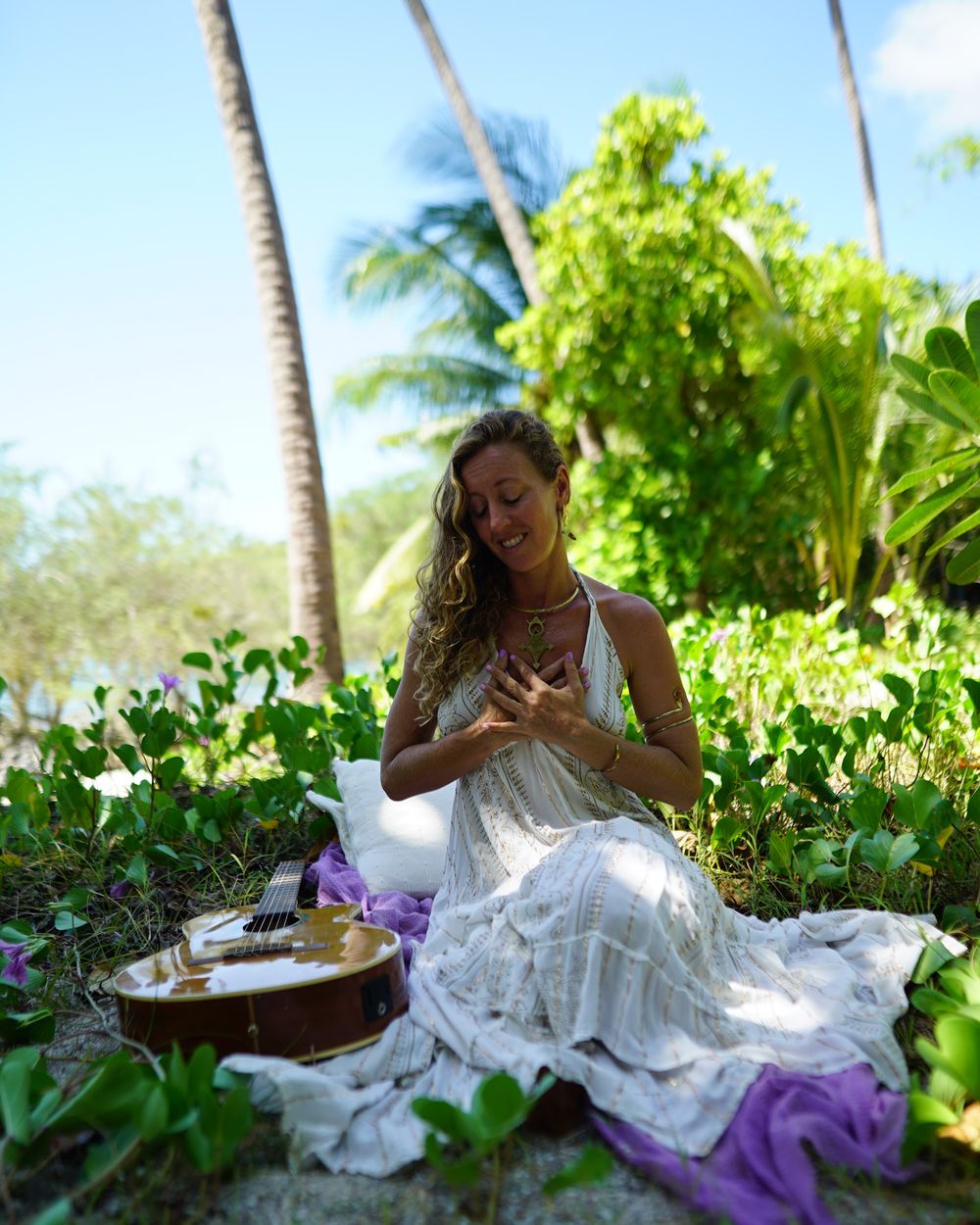 Francie La Flow sitting in meditation with her hands on her heart