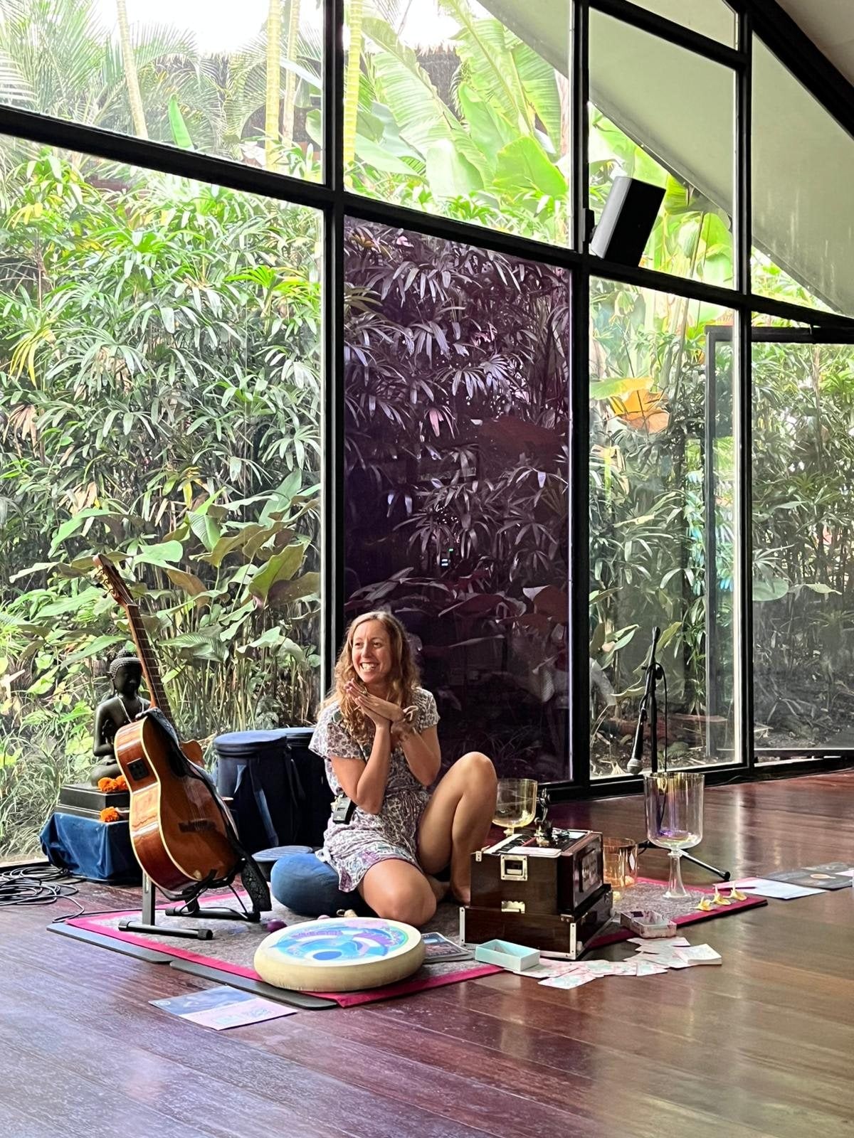 Francie La Flow teaching a Vocal Flow class at The Yoga Barn in Ubud, sitting on the floor beside her guitar